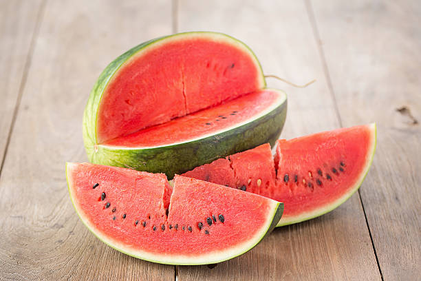 istock watermelon on brown wooden background 588210996