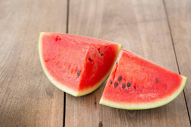 istock watermelon on brown wooden background 588211170