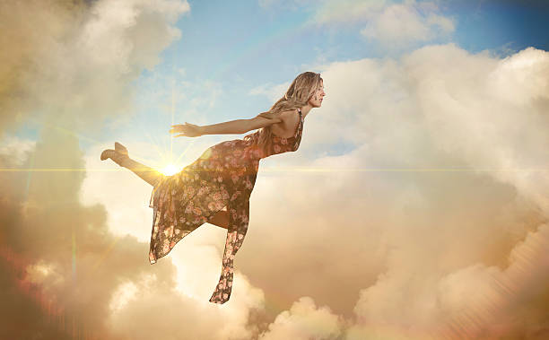 istock Magical floating woman floating in clouds 588211472