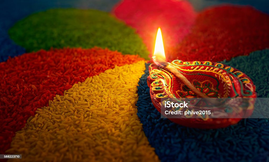 Diwali oil lamp Diwali oil lamp - Diya lamp lit on colorful rangoli Diwali Stock Photo