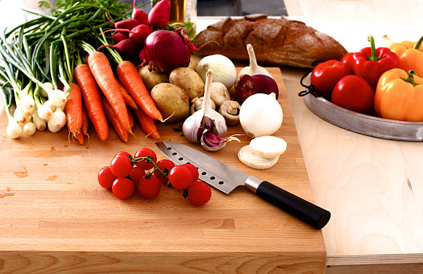 istock Pile of organic vegetables on a rustic wooden table 588224988