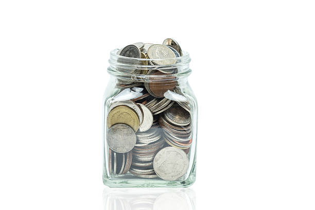 istock Glass jar of coins isolated 588226042