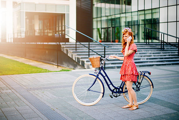 istock Woman with bicycle talking on cell phone 588229482