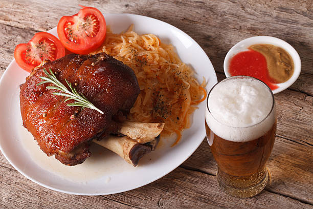 german cuisine: baked shank and sauerkraut closeup and beer - shank sauerkraut german cuisine pork imagens e fotografias de stock