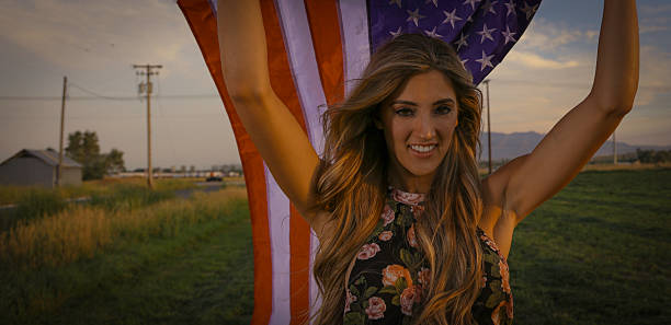 Woman with in field with american flag