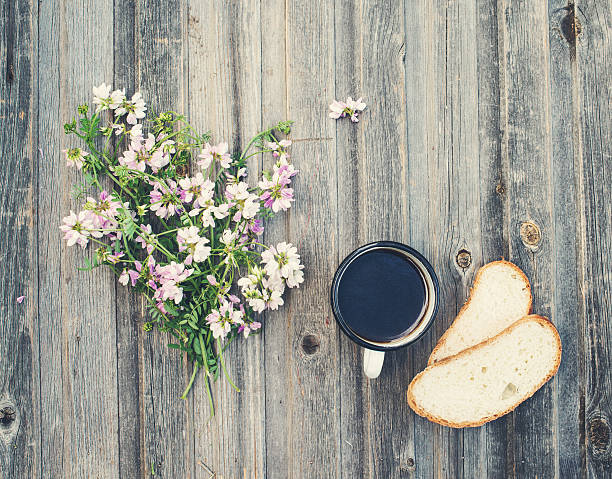 istock Retro style background. Vintage coffee mug with bread on wood. 588232366