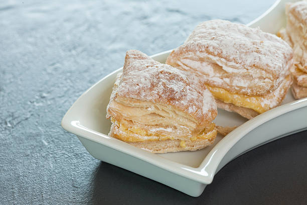 istock Puff pastry cake with cream and powdered sugar 588233552