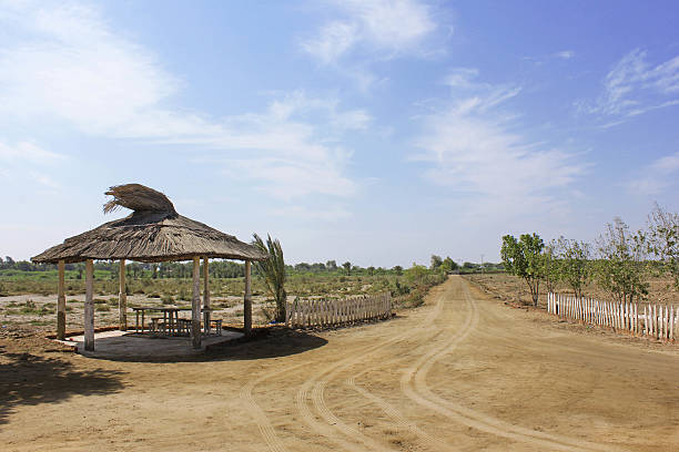 istock Hut And Path Through Beautiful Landscpae Under Blue Sky 588233924
