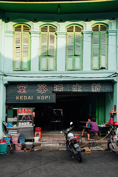 George Town, Malaysia - March 24, 2016: Woman sits at the table in the traditional kopitiam cafe in Chinatown, George Town, Penang.