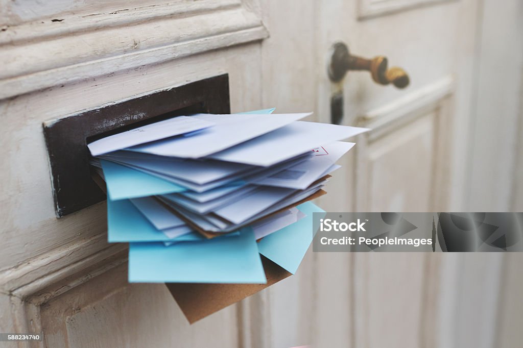 Jam-packed with the post Cropped shot of letters in a letter box Mailbox Stock Photo