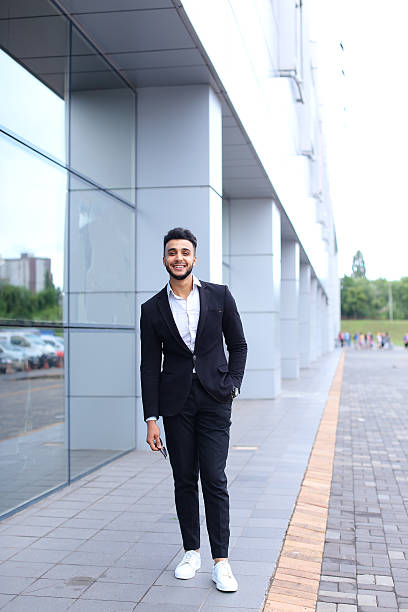 istock Arabic guy in business center stands smiling walking slow 588242744