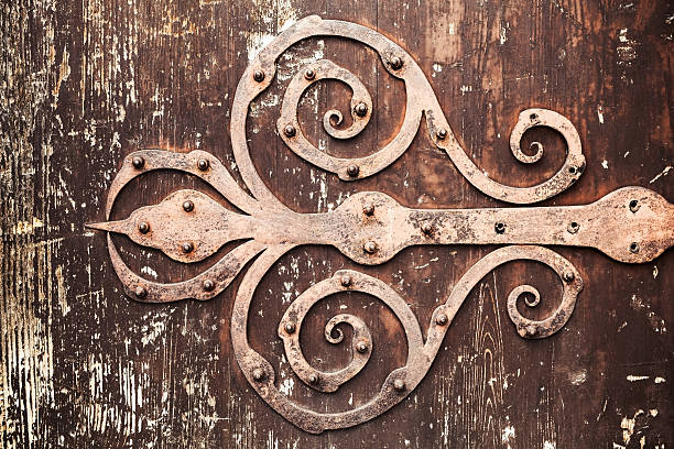istock Old rusted forged decorative door hinge 588243252