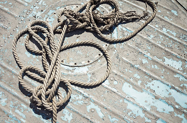 istock Knotted mooring rope on boat deck 588243750