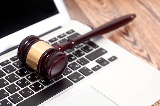 istock Judge gavel with laptop computer on wooden background 588251524