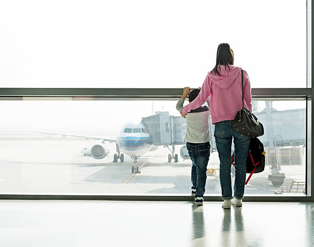 istock Asian mother and son at airport 588253176