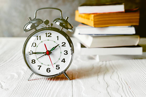 istock alarm clock time to read books 588253824