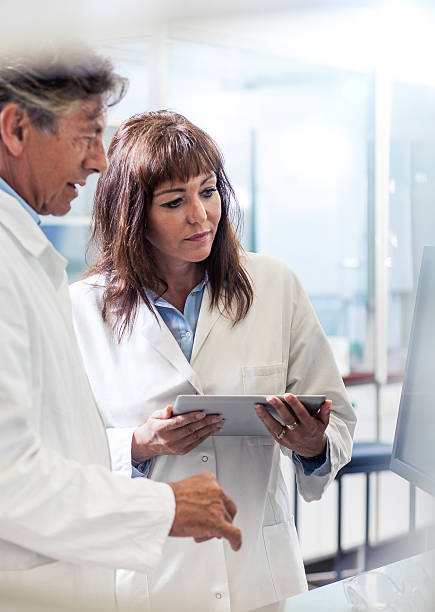 istock Scientists Discussing About New Findings 588254514