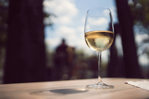 Glass of white wine on the wooden table