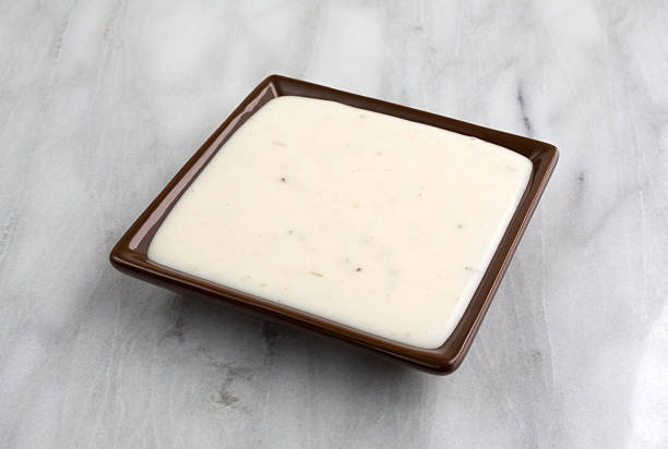 istock Small dish of Italian salad dressing on marble table top 588255856