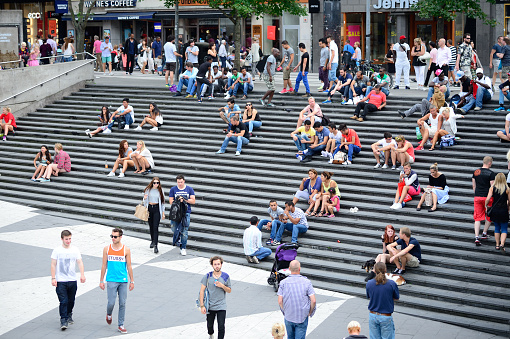 Stockholm, Sweden - August 2, 2014: Crowd in stairs. Popular resting and meeting place for shoppers, commuters or any pedestrians downtown Stockholm. The major stairs of Sergels Torg, famous landmark next to the subway entrance.