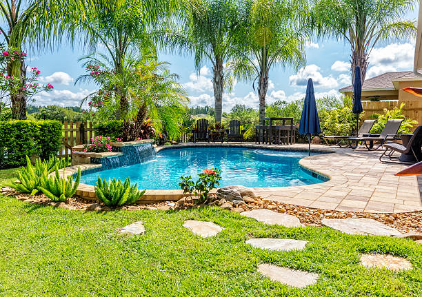 Beautiful Swimming Pool and Back Yard A beautiful backyard swimming pool in Florida. building feature stock pictures, royalty-free photos & images