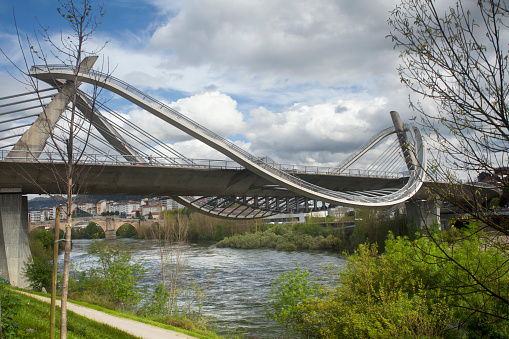 New, modern Millenium Bridge over river Miño in Ourense, Galicia, Spain. 