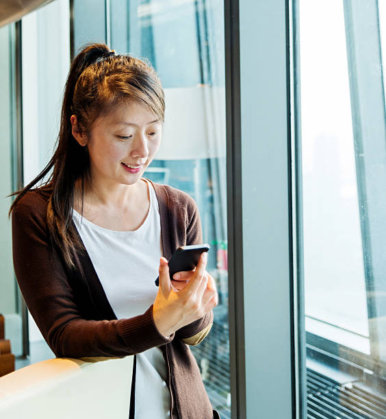 istock Young asian woman using smart phone 588262342