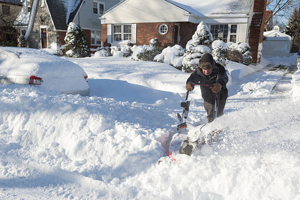 istock Senior man struggles with Snow blower in deep snow 588262686