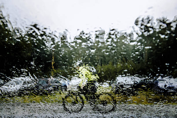 Brunssum, February 17, 2022 - Young woman defy the rain and storm by walking upwind.