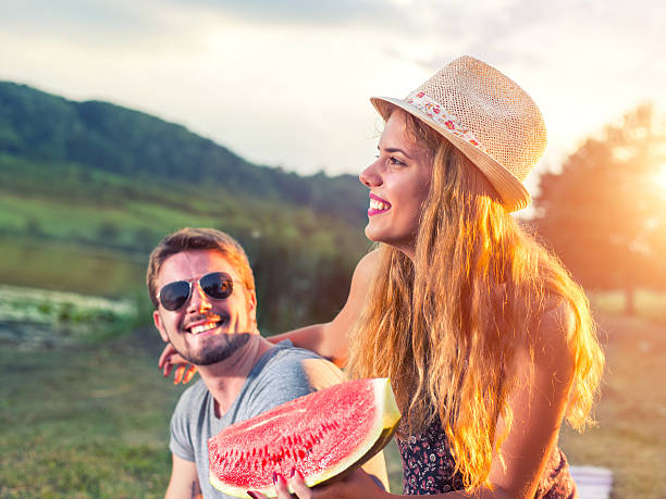 istock Happy couple eating watermelon 588264724