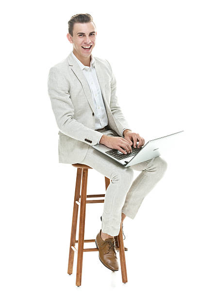 istock Smiling businessman sitting on stool 588265060