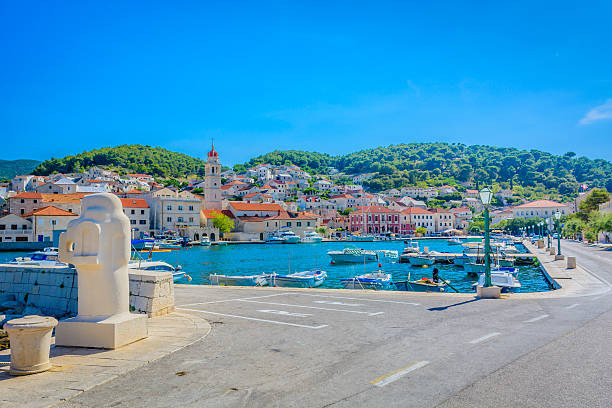 Pucisca town bay. View at promenade and cityscape in Pucisca, Island of Brac, Croatia. old catholic church on island brac croatia stock pictures, royalty-free photos & images