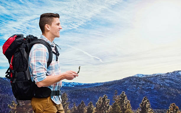 istock Smiling hiker holding compass outdoors 588269440