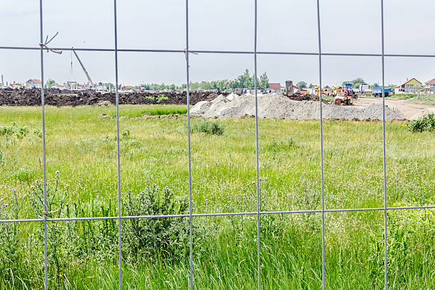 istock View on the construction site through a fence wire 588270610