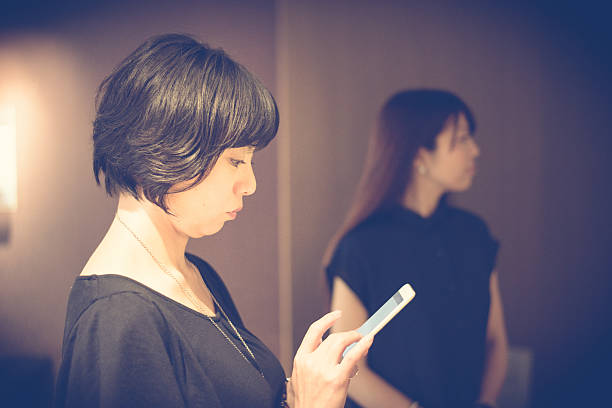 istock Japanese Businesswoman Using Smart Phone in Modern Office 588349238