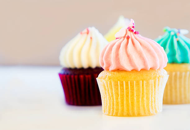 istock colorful cup cake on brown background with copy space 588350482