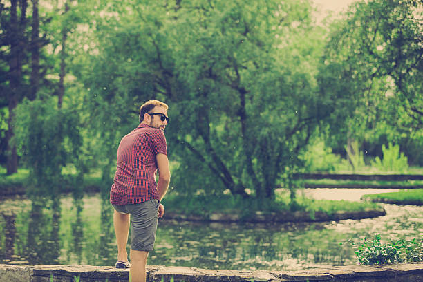 Hipster guy enjoying in nature.