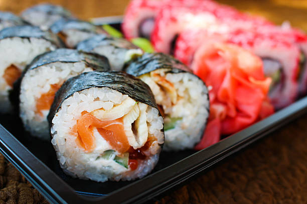 istock Sushi roll with salmon, cucumber, cheese, and caviar fish 588351862
