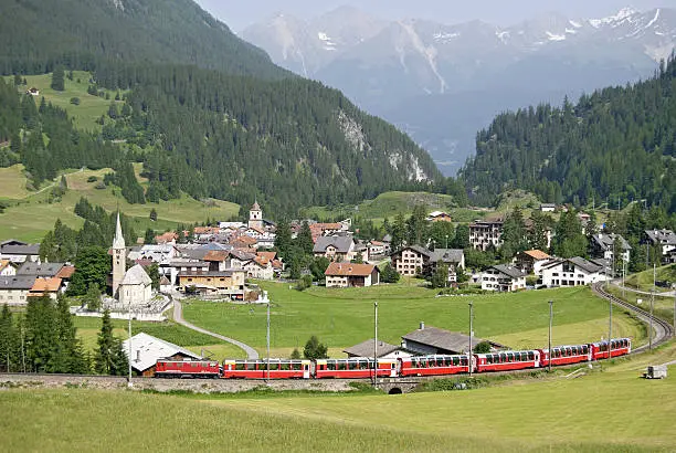 The Bernina Express from the Rhaetian Railway near the railway station of Bergün. This railway station is located on the Albula Railway line from Chur to St. Moritz. The Bernina Express is connecting Chur in Switzerland and Tirano in Italy. the train runs along the World Heritage Site known as the Rhaetian Railway in the Albula / Bernina Landscapes.