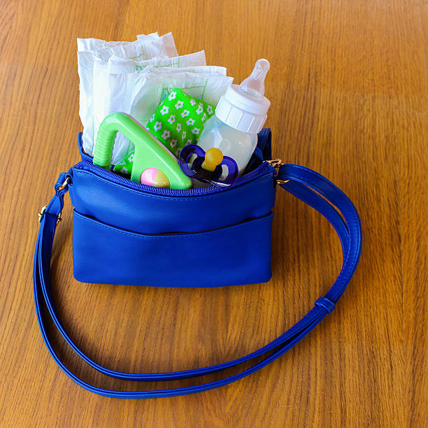 istock Women's handbag with items to care for child 588352080