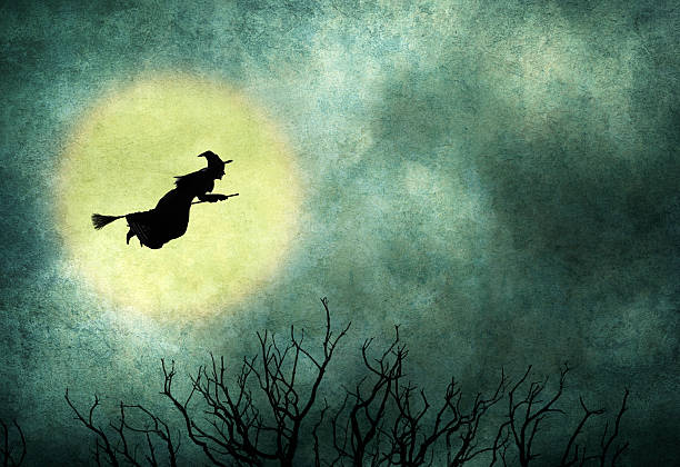 istock Witch Riding On Broom In Front Of Hazy Full Moon 588353458