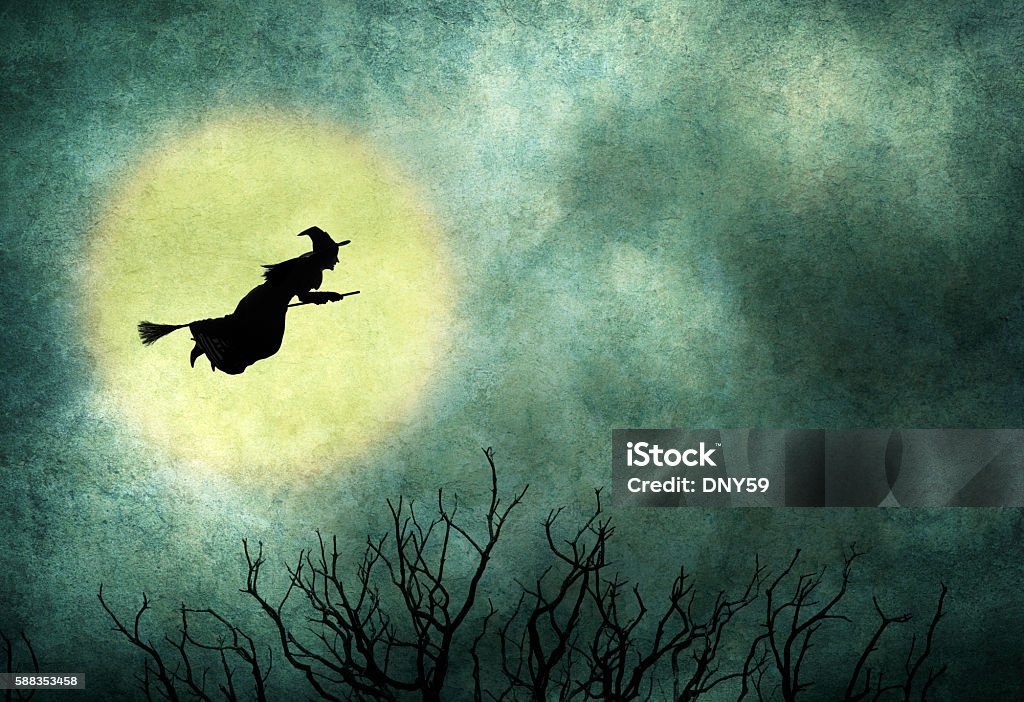 Witch Riding On Broom In Front Of Hazy Full Moon A Halloween witch and riding on a broom and a bare tree are silohuetted in front of a hazy full moon. Halloween Stock Photo