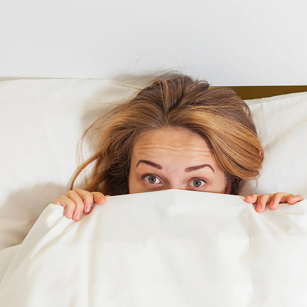istock Girl hiding under a blanket. 588353526