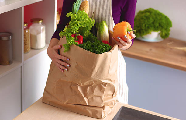 istock Assorted fruits and vegetables in brown grocery bag holding a 588354268