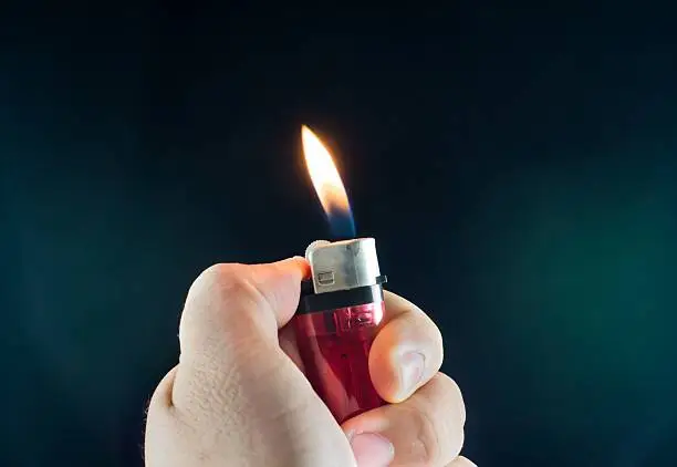 handle lighters on dark background, light caused by lighters.