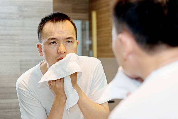 istock Young man morning skin care at bathroom. 588354370