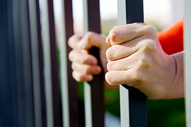 istock Gripping the steel bars 588354814