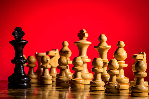 istock Chess pieces and game board closeup 588355024