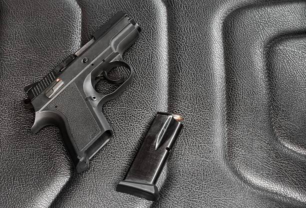 istock 9 mm pistol with magazine and ammunition 588355046