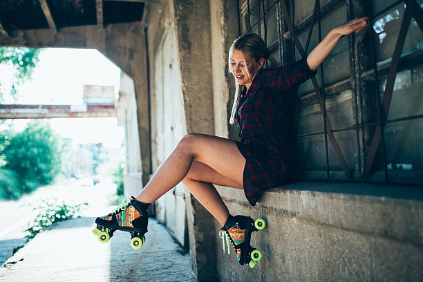 istock Girl sitting with roller skates 588358030